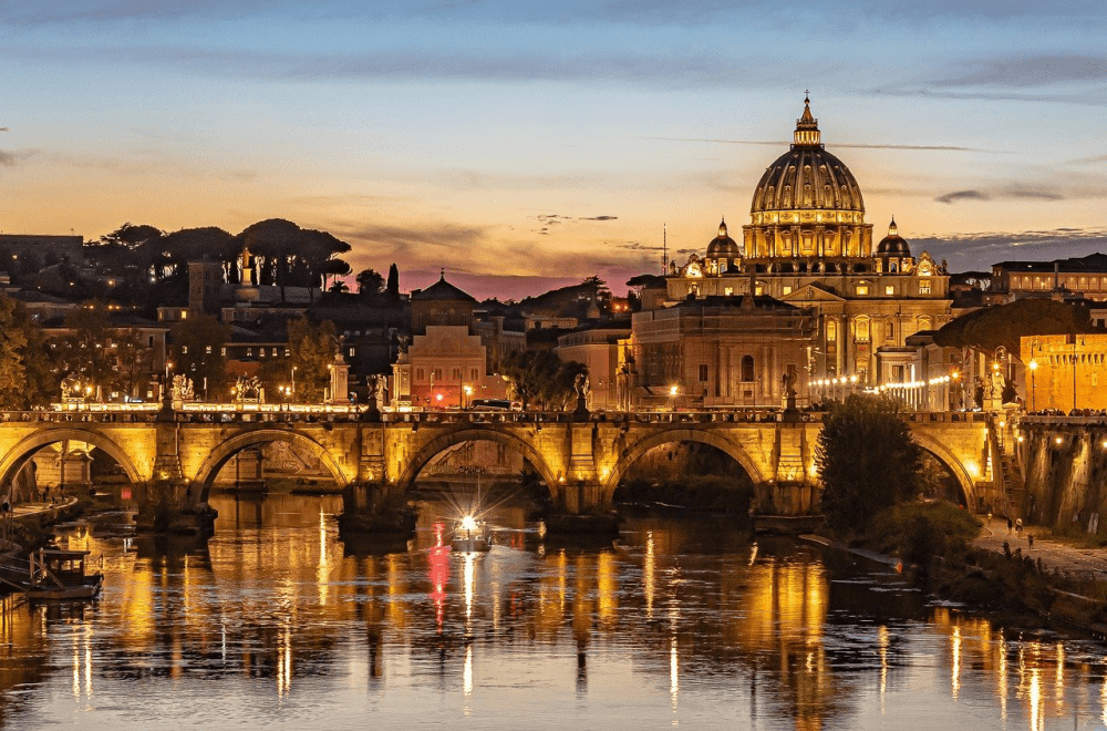 The Tiber River and St Peter's Basilica at dusk in Rome, Italy