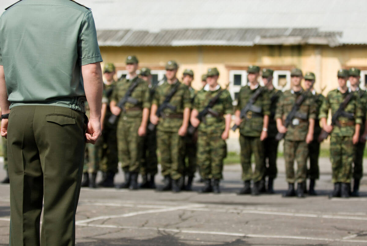 An army officer inspecting soldiers on parade